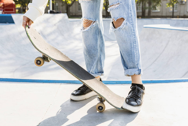 Stylish cool teen female skateboarder at skate park, close-up on shoes - Foto, Imagen
