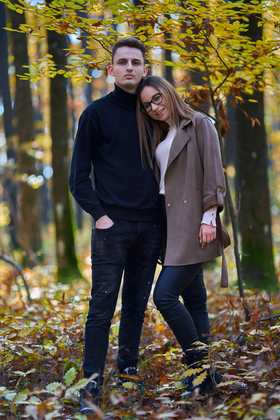 Young couple in an oak forest mid autumn - Photo, Image