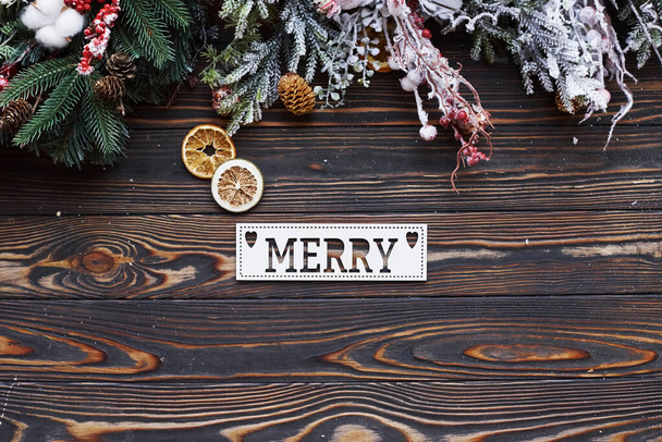 Table with merry word. Top view of christmas festive frame with new year decorations. - Foto, imagen