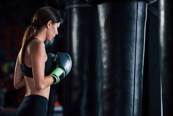 Young woman in sportive wear is in the gym having exercise day. Conception of boxing. - Fotoğraf, Görsel