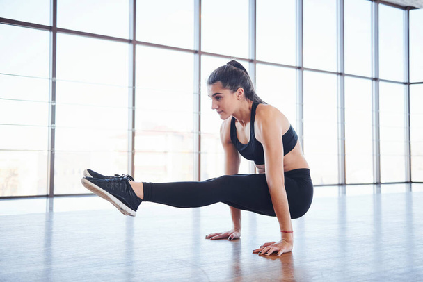 Young sporty woman in sportswear doing fitness in the gym. - Φωτογραφία, εικόνα