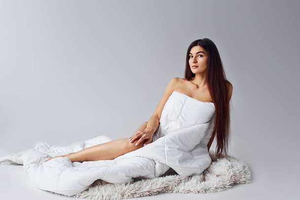 Woman in underwear sits in the studio against white background. - Fotó, kép