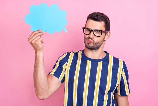 Photo of unsure young brunet guy hold cloud wear striped t-shirt eyewear isolated on pink color background - Foto, Imagen