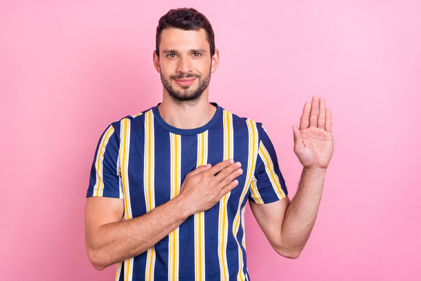 Photo of nice young brunet guy pray wear striped t-shirt isolated on pink color background - Фото, изображение
