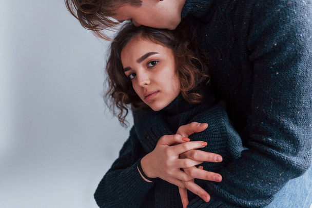 Cute young couple embracing each other indoors in the studio. - Foto, immagini
