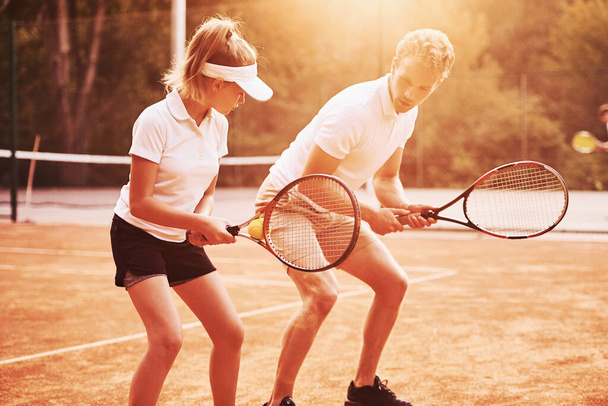 Coach teaching female student tennis game in the court outdoors. - Valokuva, kuva