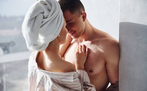 Couple at morning rime after the shower standing and embracing each other. - Foto, Imagen