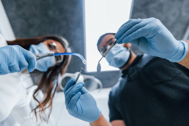 Male and female dentists working in the office together. First person view. - Foto, Imagem