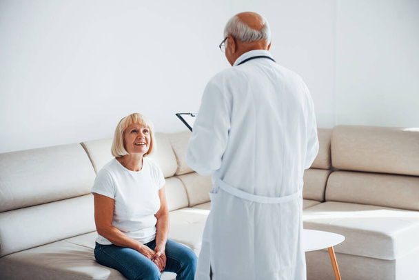 Senior woman have consultation in the clinic by the male doctor. - Photo, Image