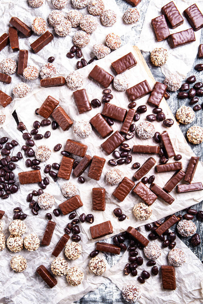 Caramelos de chocolate surtidos sobre fondo de madera. Dulces de chocolate. Fondo de postre. - Foto, Imagen
