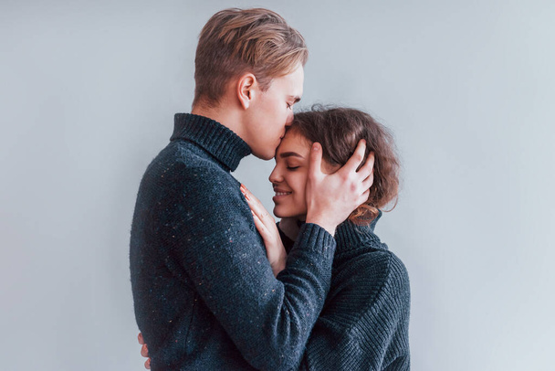 Cute young couple embracing each other indoors in the studio. - Fotoğraf, Görsel
