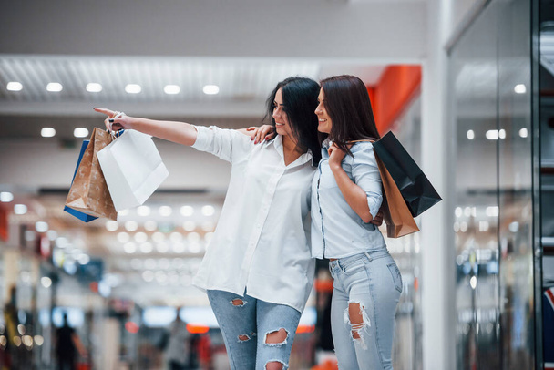 Two young women have a shopping day together in the supermarket. - 写真・画像