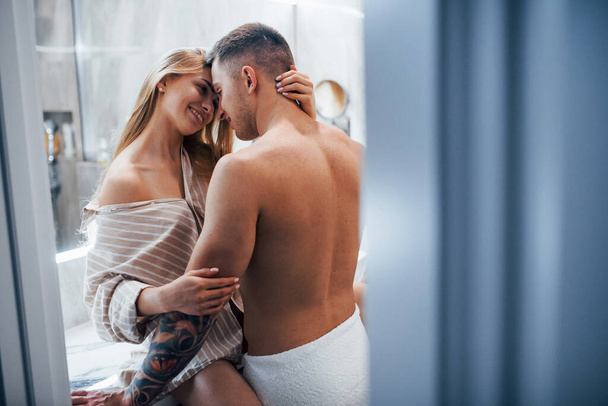 Young couple embracing and kissing each other in the bathroom. - Fotó, kép