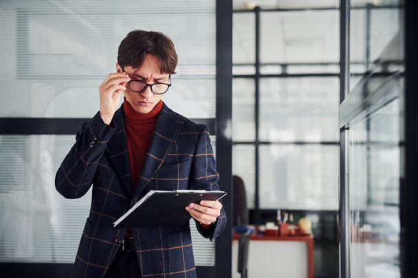 Office worker in glasses and in formal clothes standing indoors. - Photo, image