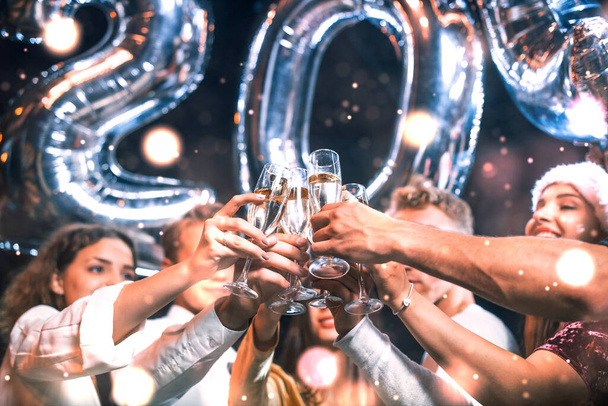 Positive young people holds balloons with new 202 year and celebrating. - Foto, imagen
