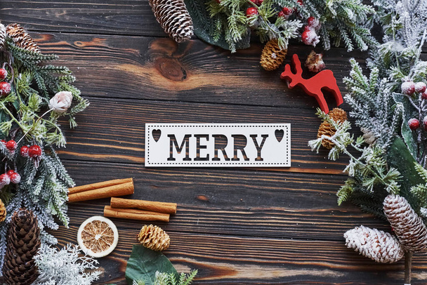 Table with merry word. Top view of christmas festive frame with new year decorations. - Zdjęcie, obraz