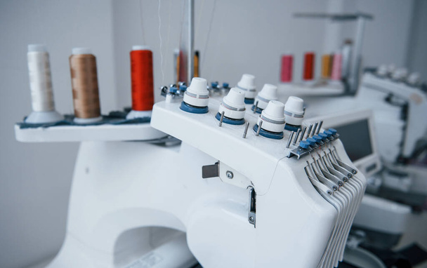 Close up view of white automatic sewing machine at factory. - Foto, Imagen