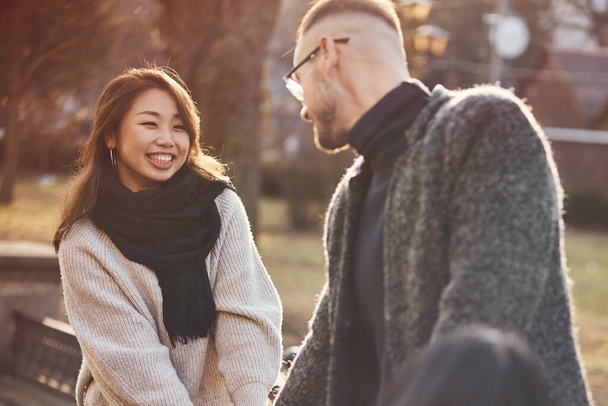 Happy multiracial couple together outdoors in the city. Asian girl with her caucasian boyfriend. - Fotoğraf, Görsel