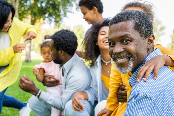 Beautiful happy african american family bonding at the park - Black family having fun outdoors - Fotografie, Obrázek