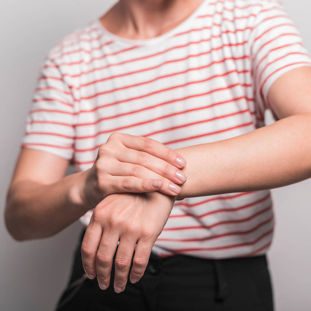 mid section young woman having pain wrist. High quality photo - Foto, immagini