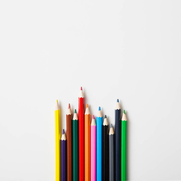 row sharp colored pencils against white background. High quality photo - Photo, Image
