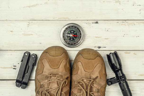Hiking boots, compass and knife. Hiking outdoor equipment - Φωτογραφία, εικόνα