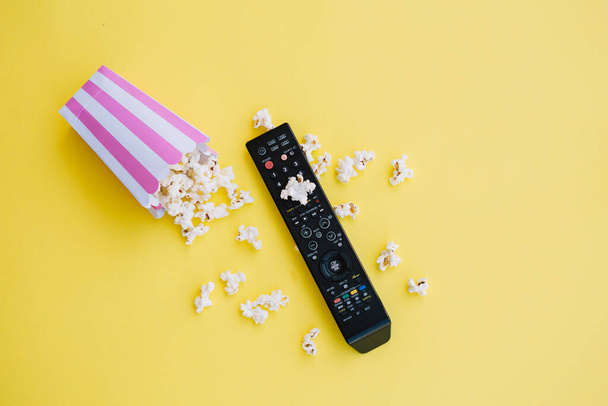 tv remote control near spilled popcorn. High quality photo - Photo, Image