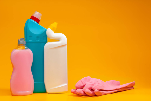 House cleaning detergent bottles on a yellow background - Zdjęcie, obraz