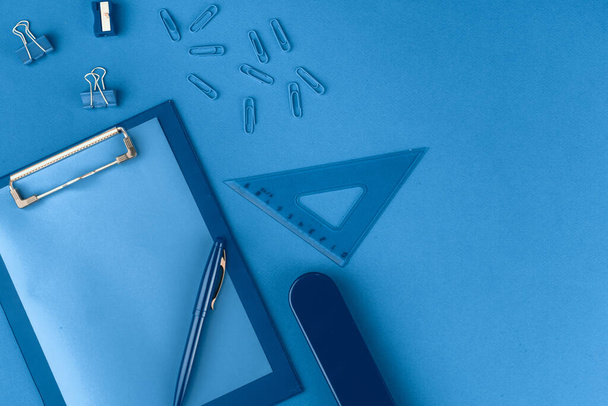 Classic blue colored top view photo of scattered stationery - Φωτογραφία, εικόνα