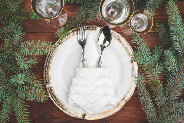 Christmas table setting with pine tree branches and decorations top view - Φωτογραφία, εικόνα