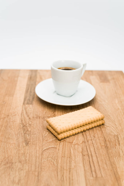 espresso coffee and biscuits on a wooden chopping board and white background with copy space - Zdjęcie, obraz
