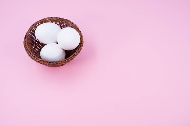 organic white eggs in a canister on a pink surface with copy space for text - Fotó, kép