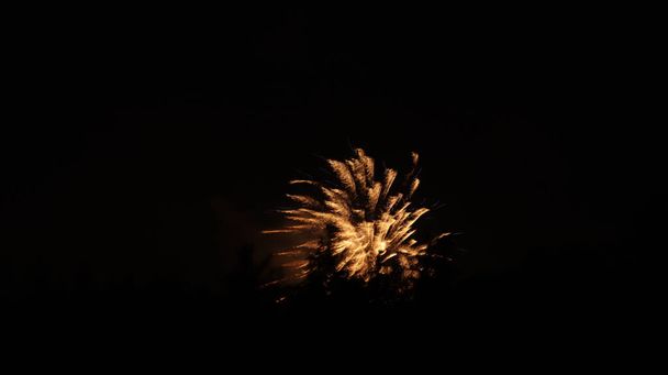 The exploding gold fireworks on a black background - Valokuva, kuva