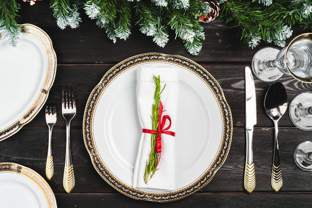 Festive table setting with pine tree branches on wooden background - Valokuva, kuva