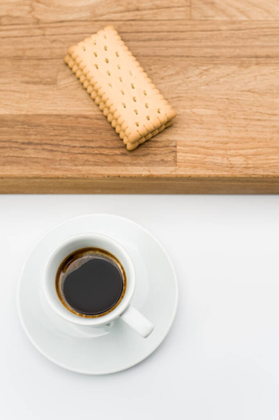 espresso coffee and biscuits on a wooden chopping board and white background with copy space - Foto, Imagem