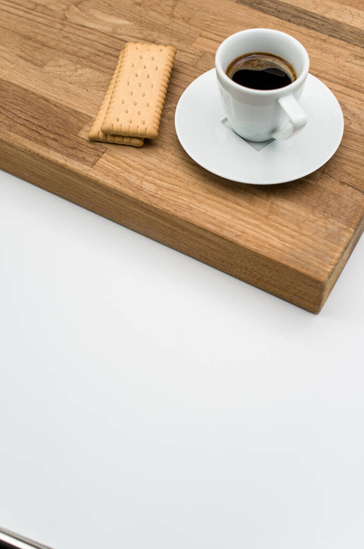 espresso coffee and biscuits on a wooden chopping board and white background with copy space - Foto, Imagem