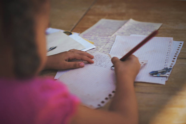 Retro- und Vintage-Konzept. Ein kleines Mädchen schreibt einen Brief mit Tuschestift, alte Umschläge - Foto, Bild