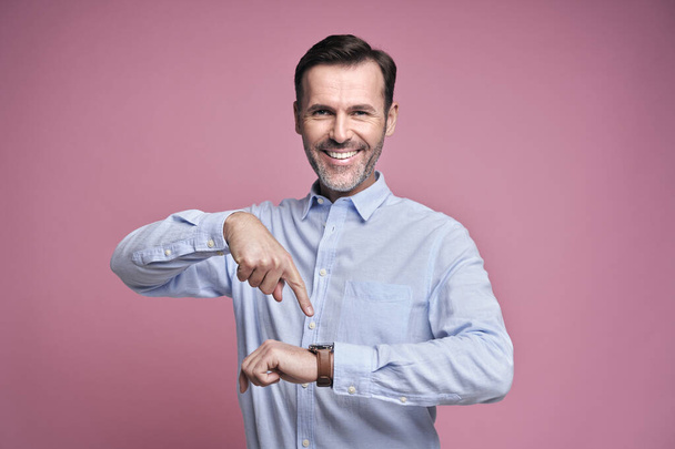 Happy man showing for smart watch                                 - Photo, Image