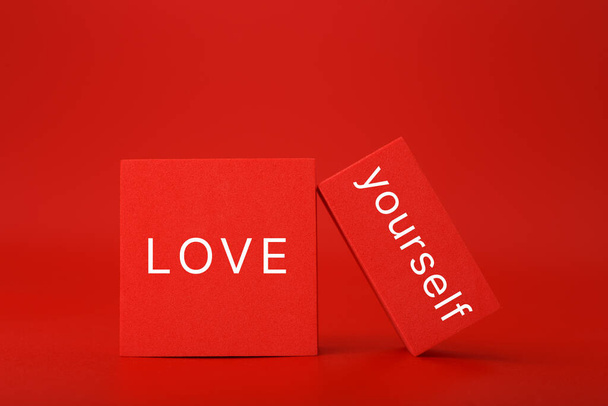 Self love, being single and mental health minimal creative concept in red colors. Text on red geometric shapes - 写真・画像