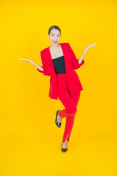 Portrait beautiful young asian woman smile with action on color background - 写真・画像