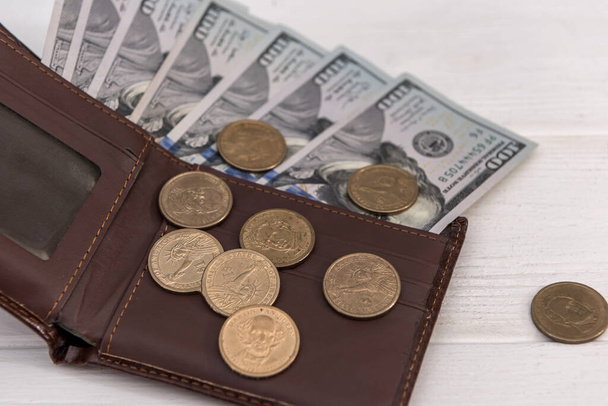 American dollars and cents in dark leather wallet. Business financial concept. - Фото, изображение