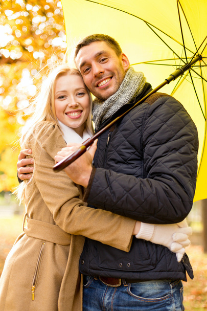 smiling couple hugging in autumn park - Фото, изображение