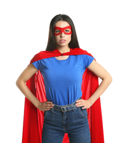 Confident young woman wearing superhero cape and mask on white background - Φωτογραφία, εικόνα