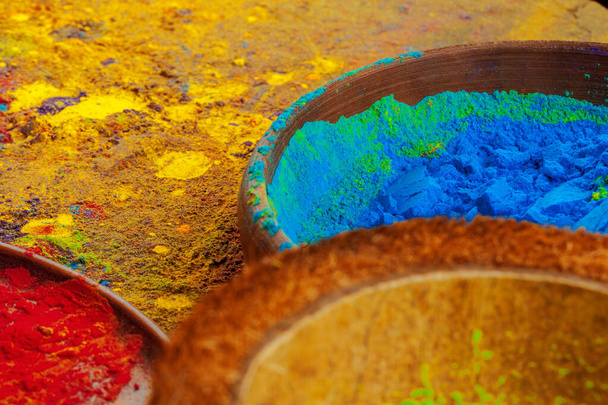 Bows of colorful Holi power close up on floor - Φωτογραφία, εικόνα