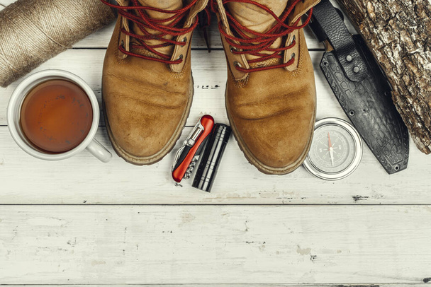 Hiking boots, compass and knife. Hiking outdoor equipment - 写真・画像