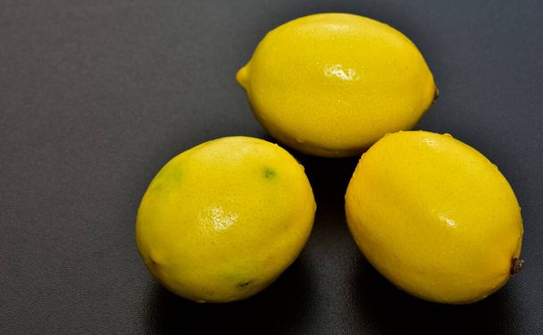 three lemons on a black background - Photo, Image