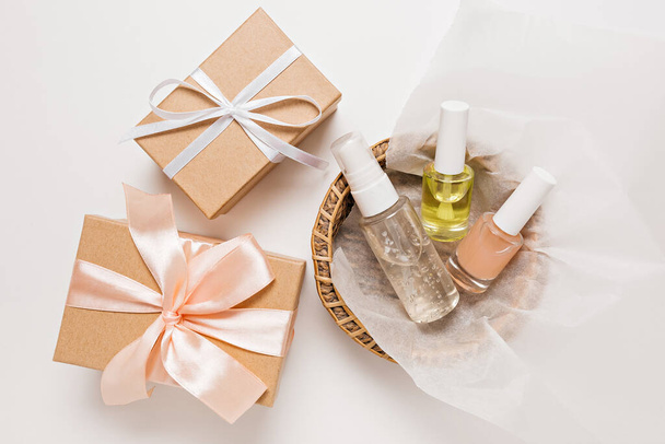 Organic cosmetics and gifts for the holiday. Flat lay, top view clear glass pump bottle, brush jar, moisturizing serum jar in a paper basket on a white background. Natural cosmetics SPA - Fotó, kép