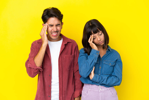 Young mixed race couple isolated on yellow background unhappy and frustrated with something - Zdjęcie, obraz