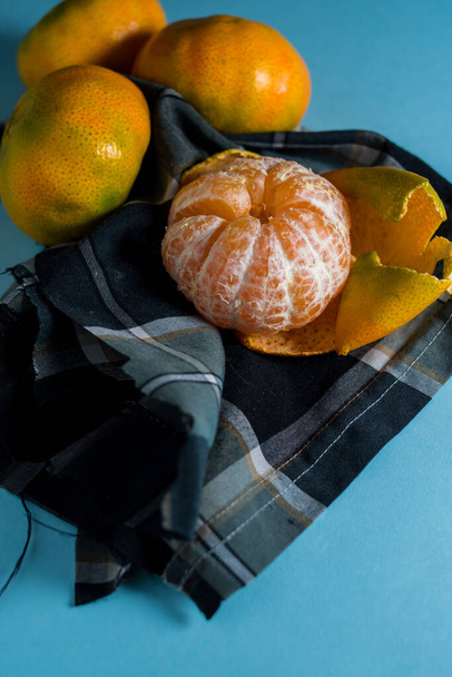 The fresh ripe mandarins isolated on blue background - Photo, Image