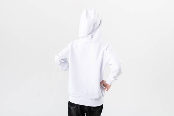 Rear view of a child in a white hoodie. - Фото, изображение